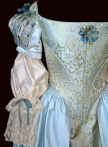 close-up of seventeenth century restoration-style wedding corset and skirt in blue-gold brocade
