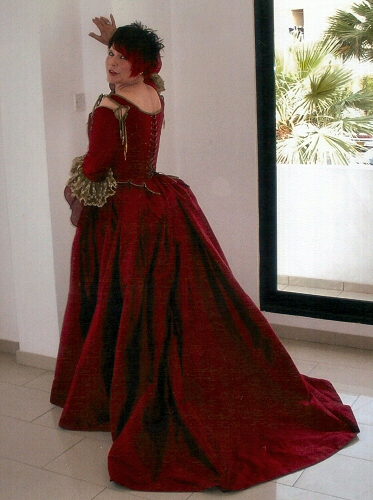 red 18th century stle wedding corset with frills at elbow and matching skirt