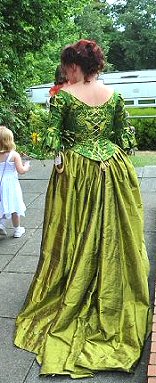 back view of green and gold brocade 18th century style corset with lime green silk skirt