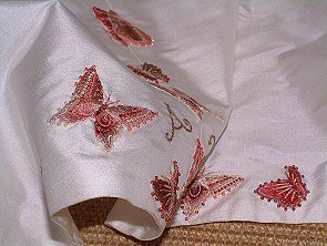embroidered butterflies applied around the hem