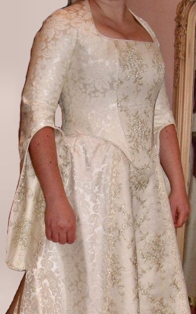 ivory damask medieval style wedding dress with hanging sleeves and gold embroidered panels