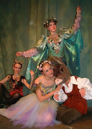 Both costumes are in shades of pale green, lilac, soft blue and pink. Titania's (back-laced) bodice is in a green/gold shot silk dupion, with a swag of flowers and leaves from the shoulder to the hip and has sparkling wired wings. The gold spotted tulle topskirt gives hints of the layers of blue and lilac beneath, especially
as the performer moves. For the most recent incarnation of this costume, the tulle was chopped into quite drastically to make the skirt layers more erratic and to show the base colours more.