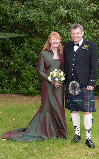  mossy green silk wedding corset with shrug jacketand tapered skirt