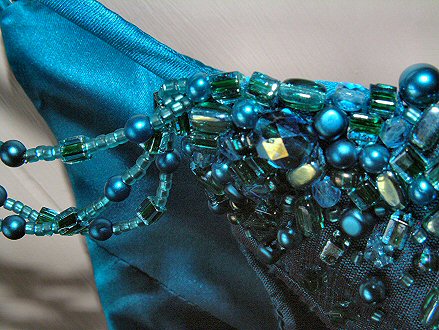 The jewels take it to another level. Cut glass beads give flashes of rainbow light, peacock blue pearls and sea-green crystals combine to provide even more depth of colour - blues and greens mixing in all possible tones.  