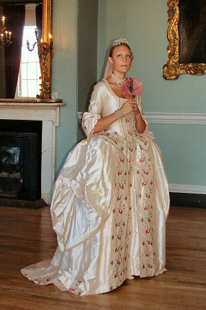 A stunning eighteenth century style wedding dress in cloud pink regal dupion. This period style wedding gown consists of a corseted jacket/ bodice with a seperate skirt worn over pannier supports.